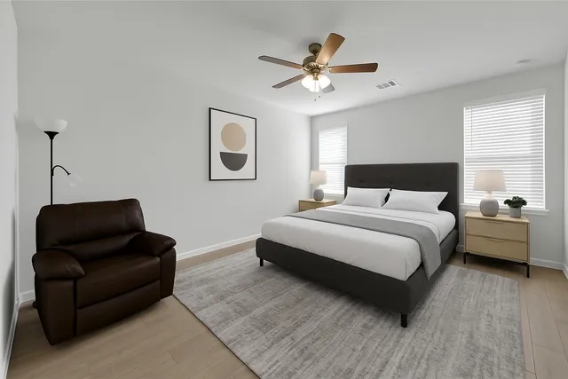 a bedroom with a bed couch and window