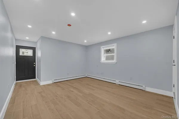 an empty room with windows and closet