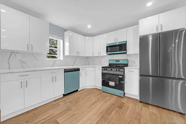 a kitchen with a refrigerator stove and wooden cabinets