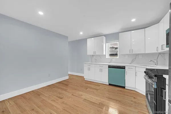 a kitchen with granite countertop white cabinets and white appliances