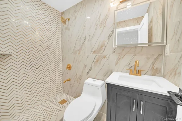 a bathroom with a sink a toilet and mirror