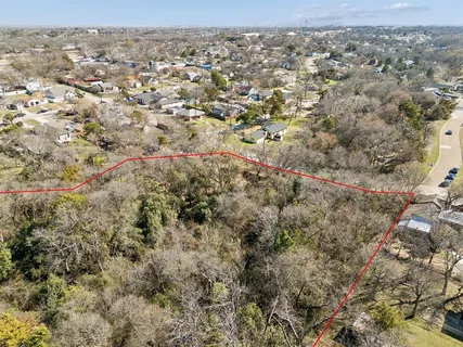 an aerial view of house with yard and mountain view in back