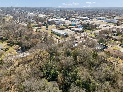 an aerial view of house with yard and mountain view in back