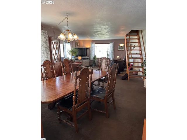 a view of a dining room with furniture and chandelier