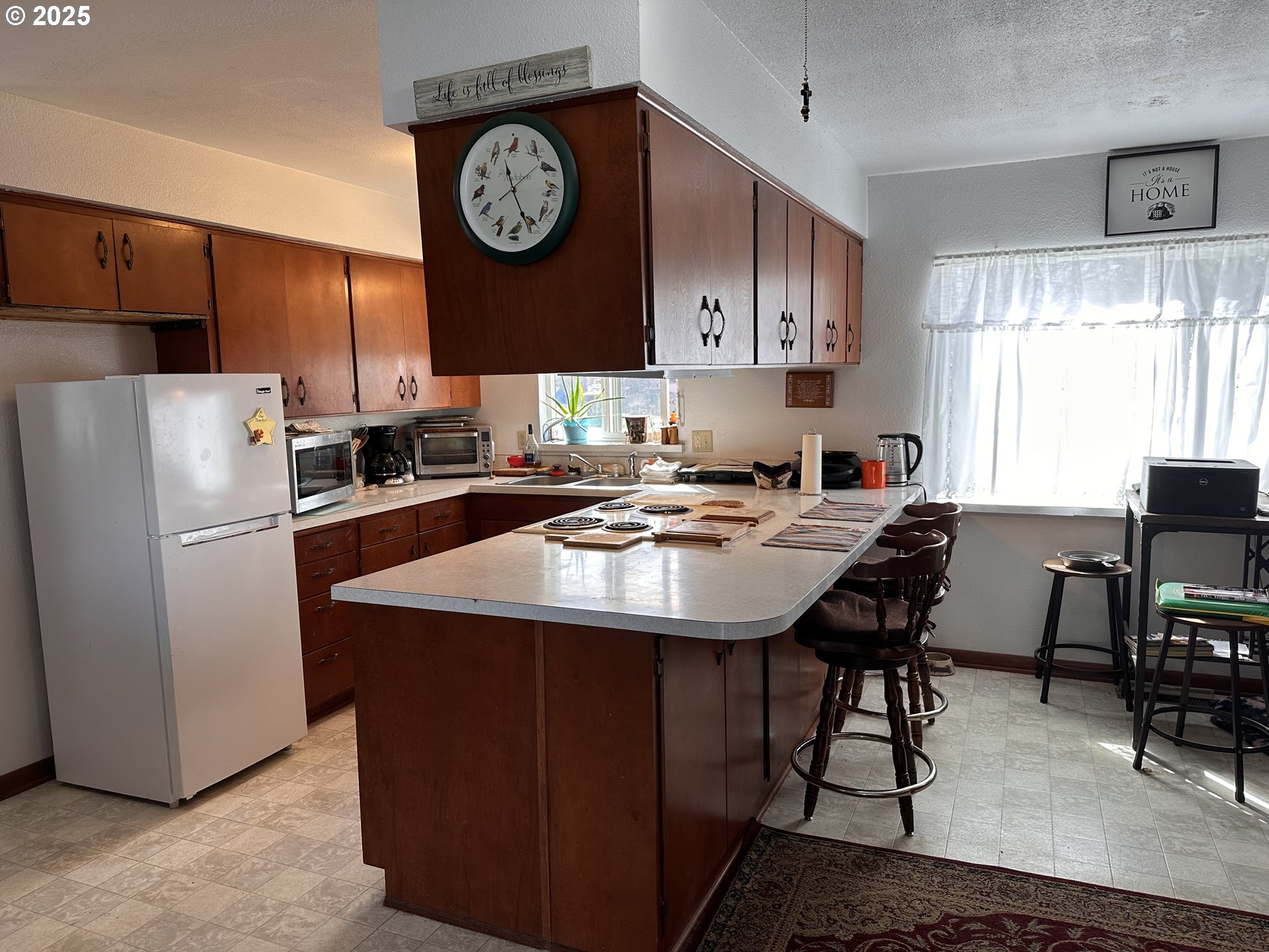 309 East Van Buren Street Athena, OR 97813 - Photo 12 of 31 a kitchen with a sink and a clock on the wall