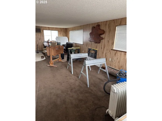a view of a house with a balcony and wooden fence