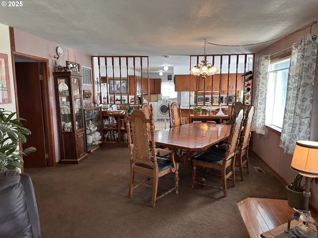 a dining room with furniture window and wooden floor