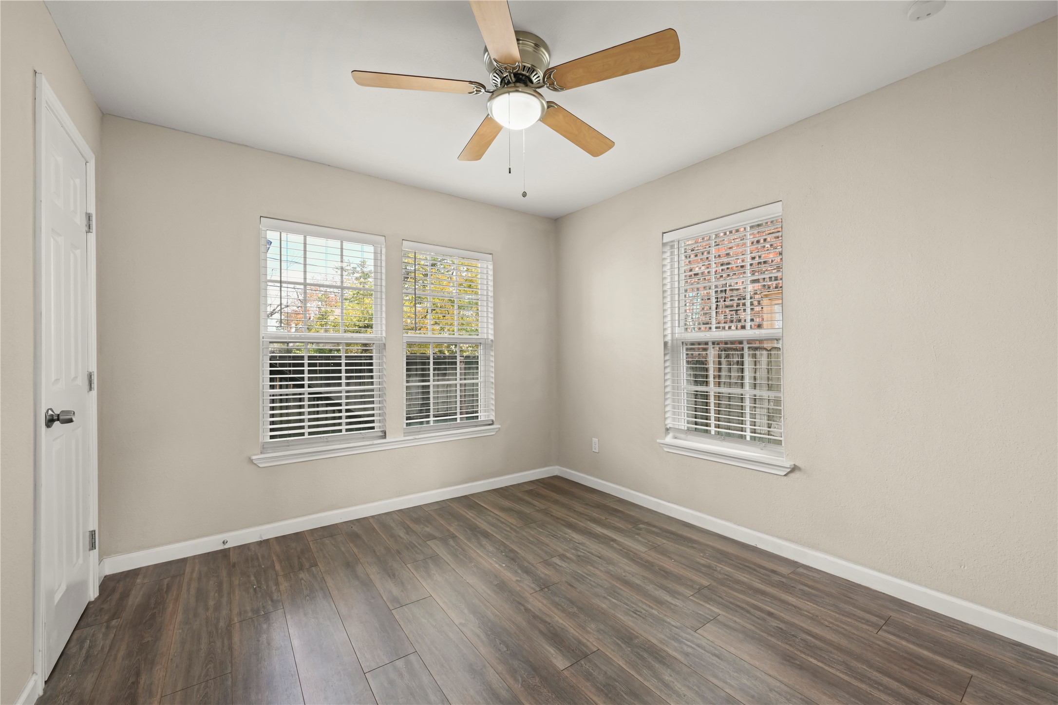 2803 Cleburne Street, Unit 3 Houston, TX 77004 - Photo 7 of 8 an empty room with wooden floor and windows