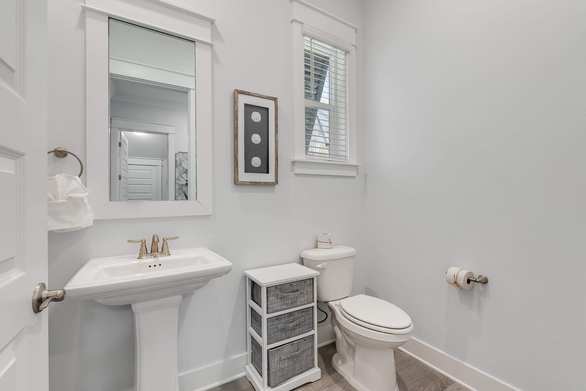 239 Milestone Drive, Unit A Inlet Beach, FL 32461 - Photo 18 of 39 a white toilet sitting next to a bathroom sink