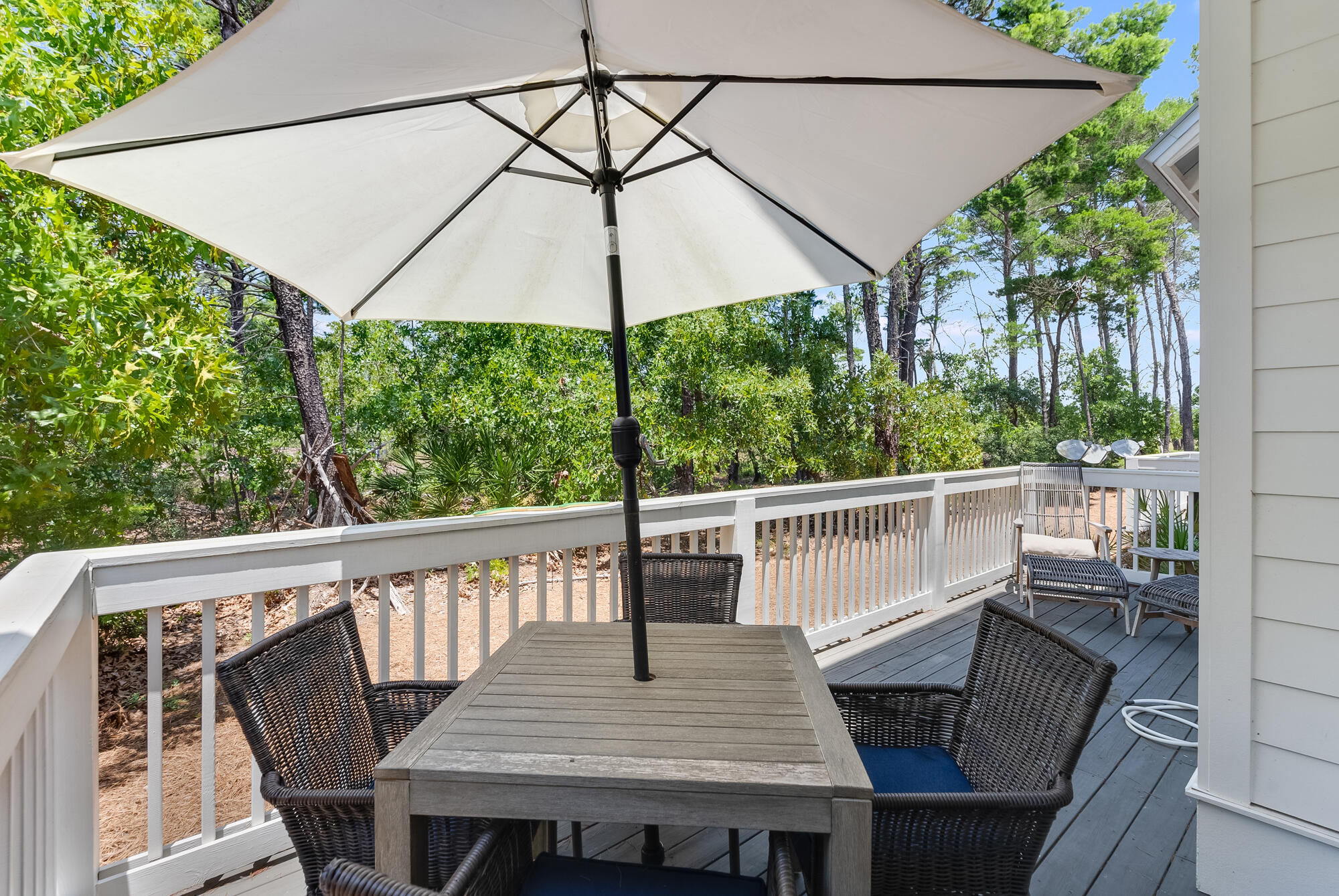 239 Milestone Drive, Unit A Inlet Beach, FL 32461 - Photo 7 of 39 a view of balcony with furniture and umbrella