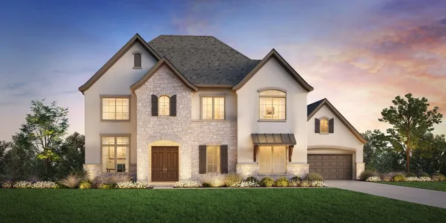 a front view of a house with a yard and trees