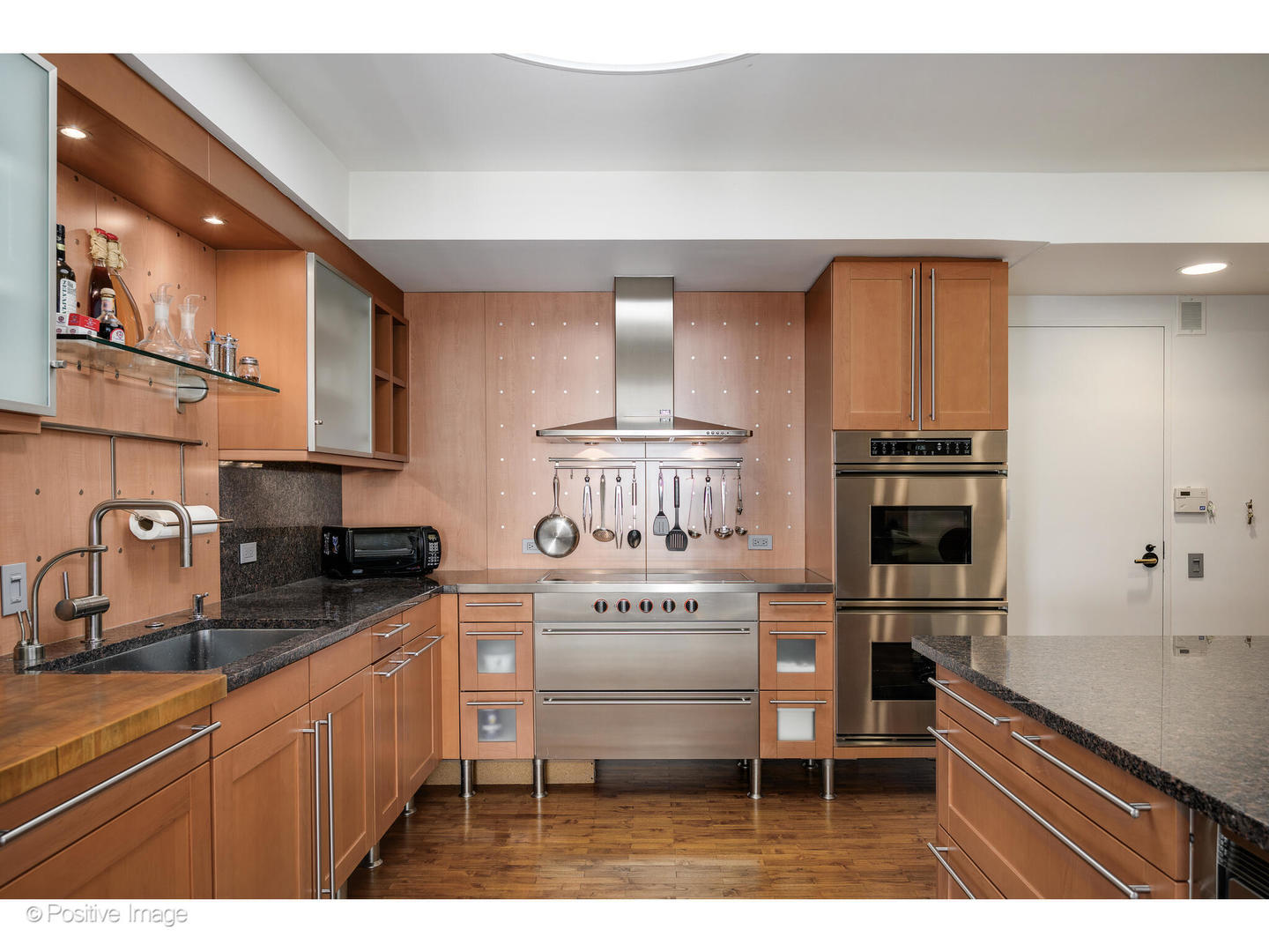 175 East Delaware Place, Unit 5116 Chicago, IL 60611 - Photo 12 of 43 a kitchen with stainless steel appliances a stove a sink and a refrigerator