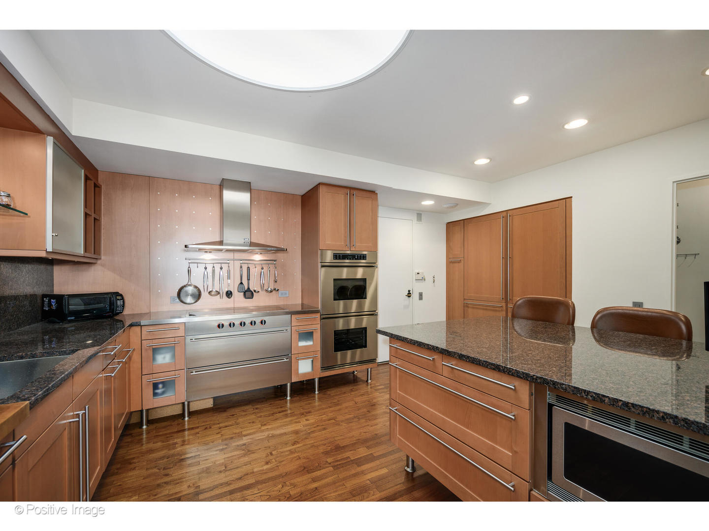 175 East Delaware Place, Unit 5116 Chicago, IL 60611 - Photo 13 of 43 a kitchen with stainless steel appliances granite countertop a stove and a sink