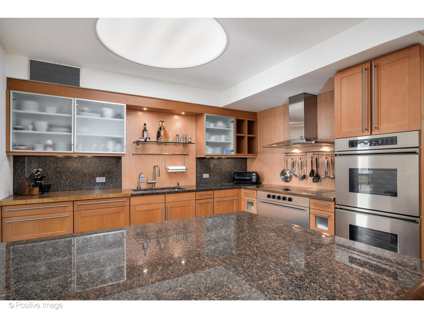 175 East Delaware Place, Unit 5116 Chicago, IL 60611 - Photo 15 of 43 a kitchen with stainless steel appliances granite countertop a refrigerator and cabinets