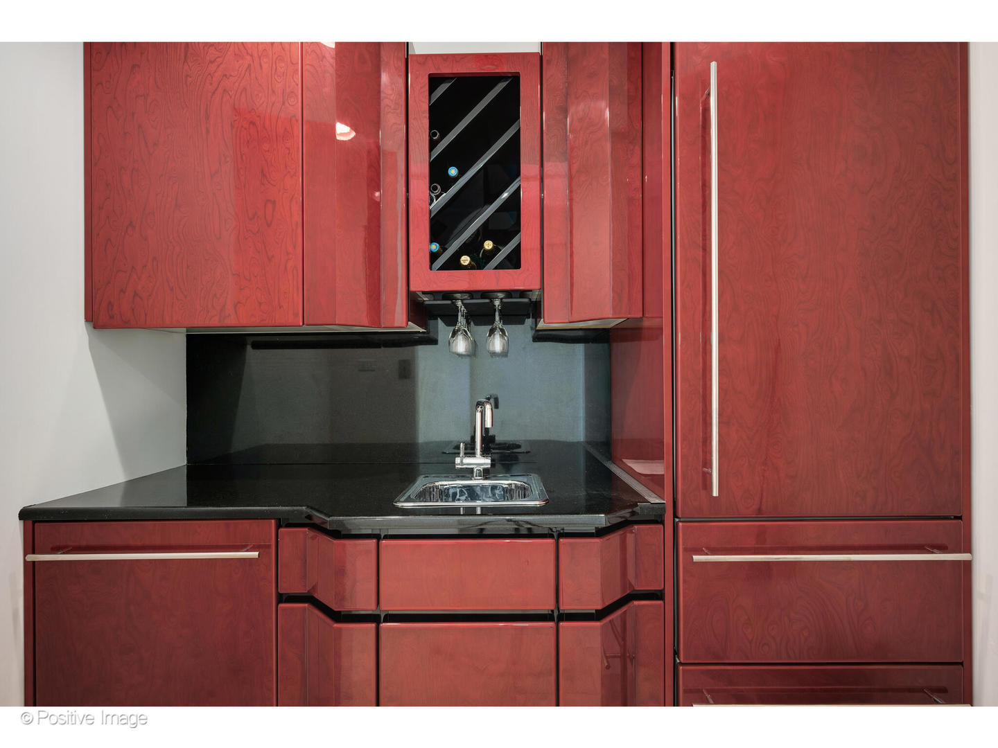 175 East Delaware Place, Unit 5116 Chicago, IL 60611 - Photo 17 of 43 a kitchen with wooden cabinets and a sink