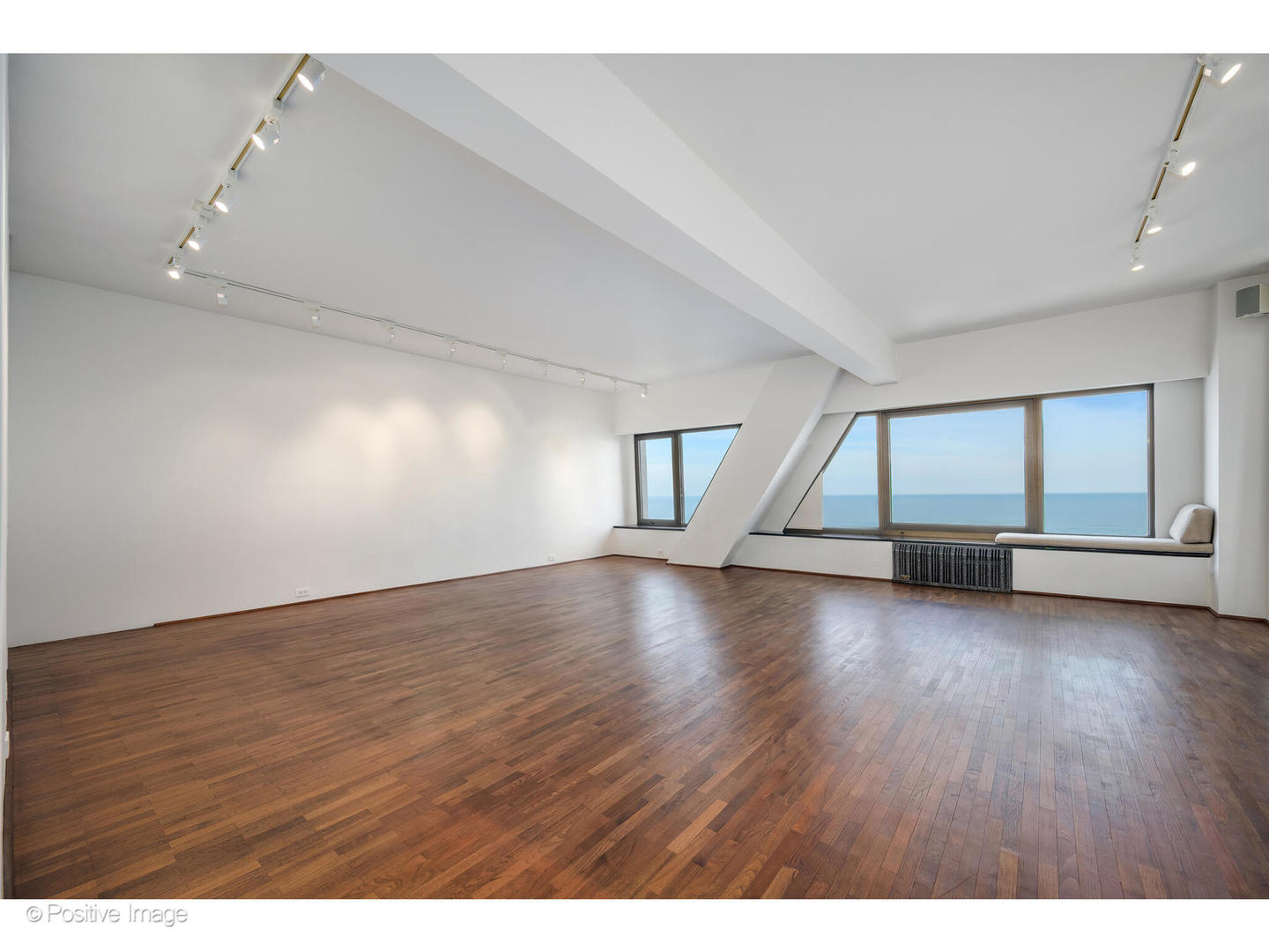 175 East Delaware Place, Unit 5116 Chicago, IL 60611 - Photo 19 of 43 an empty room with wooden floor and windows