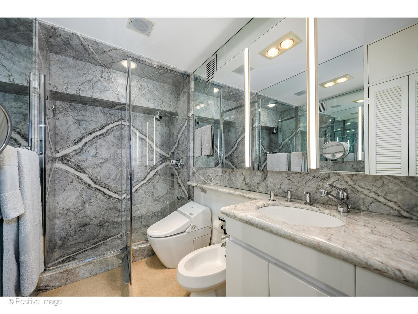 175 East Delaware Place, Unit 5116 Chicago, IL 60611 - Photo 22 of 43 a bathroom with a granite countertop sink toilet a mirror and shower
