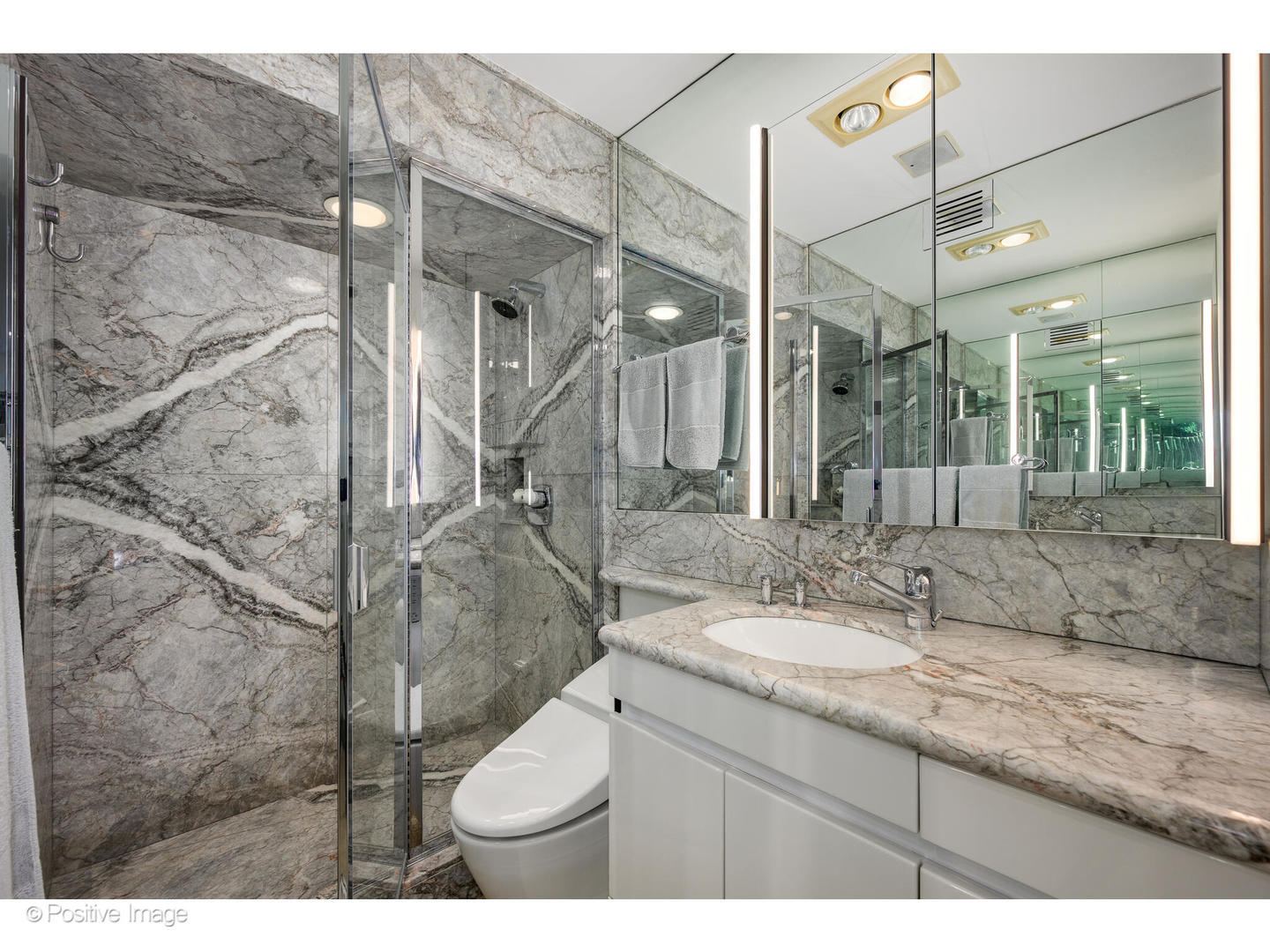 175 East Delaware Place, Unit 5116 Chicago, IL 60611 - Photo 23 of 43 a bathroom with a granite countertop sink a toilet and a mirror