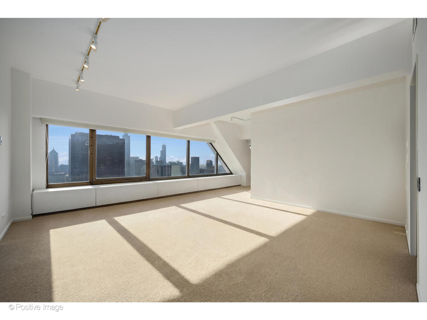 175 East Delaware Place, Unit 5116 Chicago, IL 60611 - Photo 32 of 43 a view of an empty room with wooden floor and a window