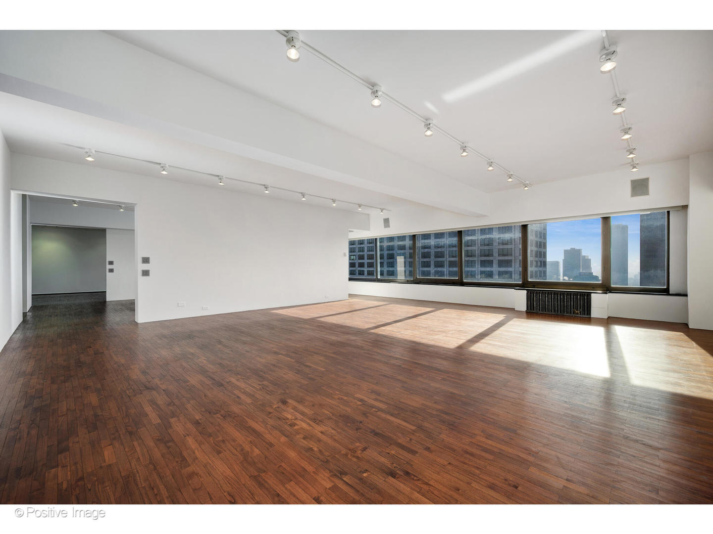 175 East Delaware Place, Unit 5116 Chicago, IL 60611 - Photo 4 of 43 a view of an empty room with wooden floor and a window