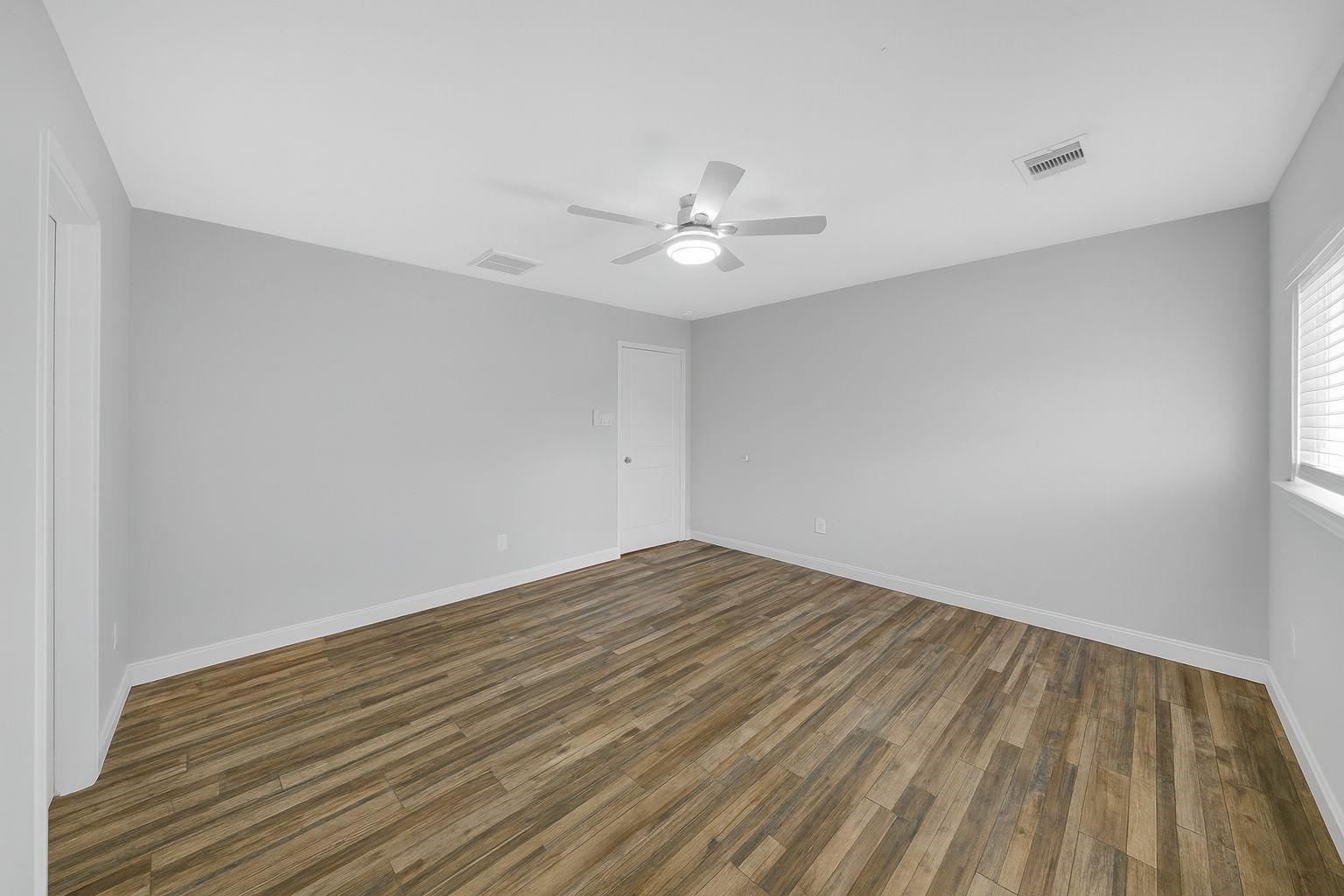 4732 Carmen Street, Unit A Houston, TX 77033 - Photo 17 of 26 a view of empty room with wooden floor