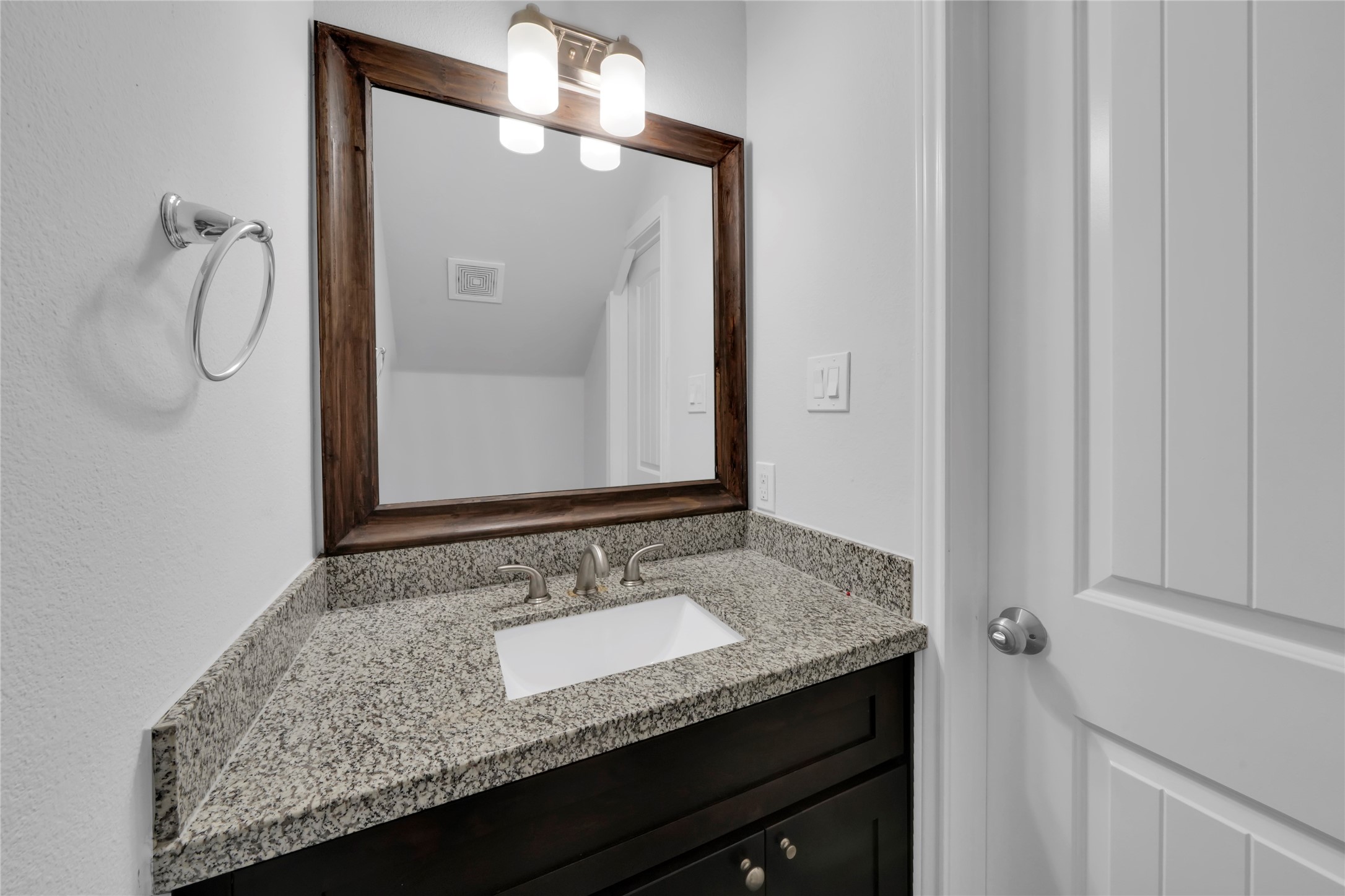 4732 Carmen Street, Unit A Houston, TX 77033 - Photo 23 of 26 a bathroom with a granite countertop sink and mirror