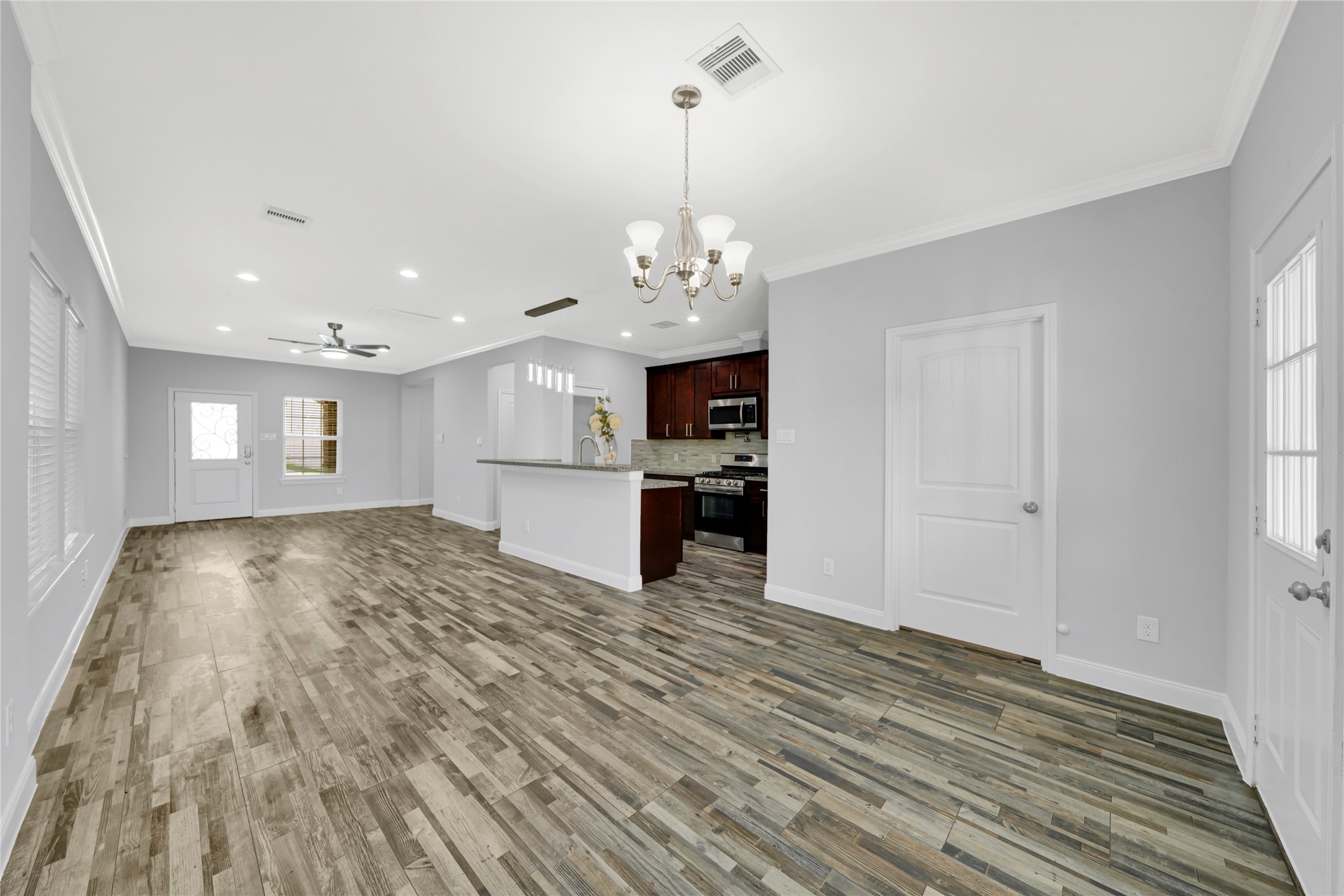 4732 Carmen Street, Unit A Houston, TX 77033 - Photo 8 of 26 a view of a kitchen with microwave and cabinets