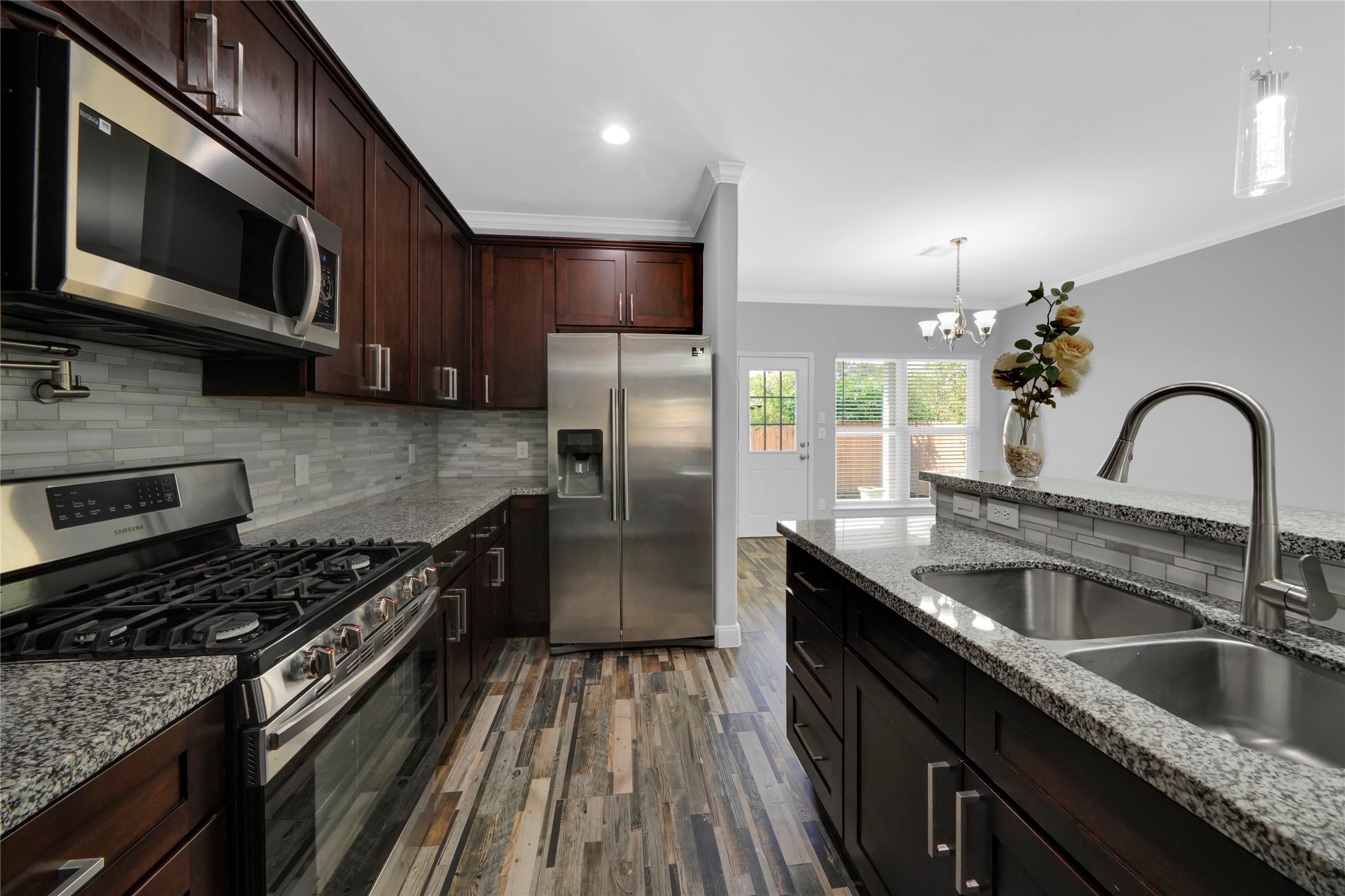4732 Carmen Street, Unit A Houston, TX 77033 - Photo 10 of 26 a kitchen with granite countertop a sink stainless steel appliances and cabinets