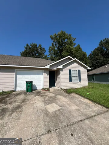 a view of a house with a yard and garage
