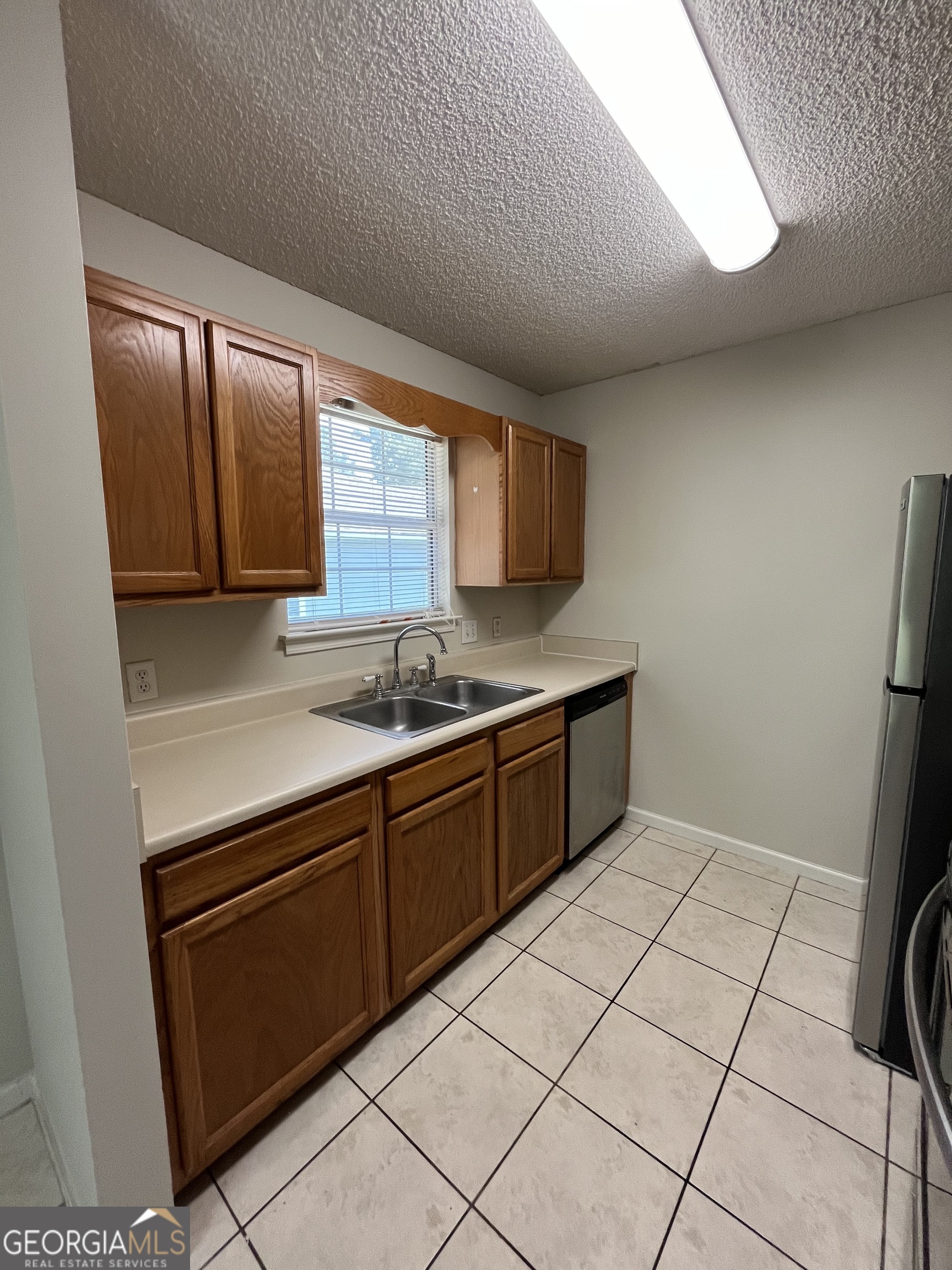 120 Sapelo Drive St. Marys, GA 31558 - Photo 14 of 24 a kitchen with a sink cabinets and window