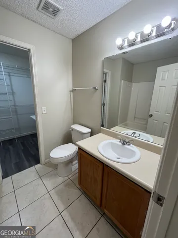 a bathroom with a sink toilet and mirror