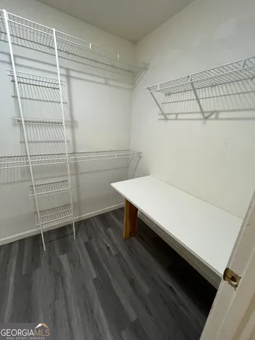 a bathroom with a sink and wooden floor