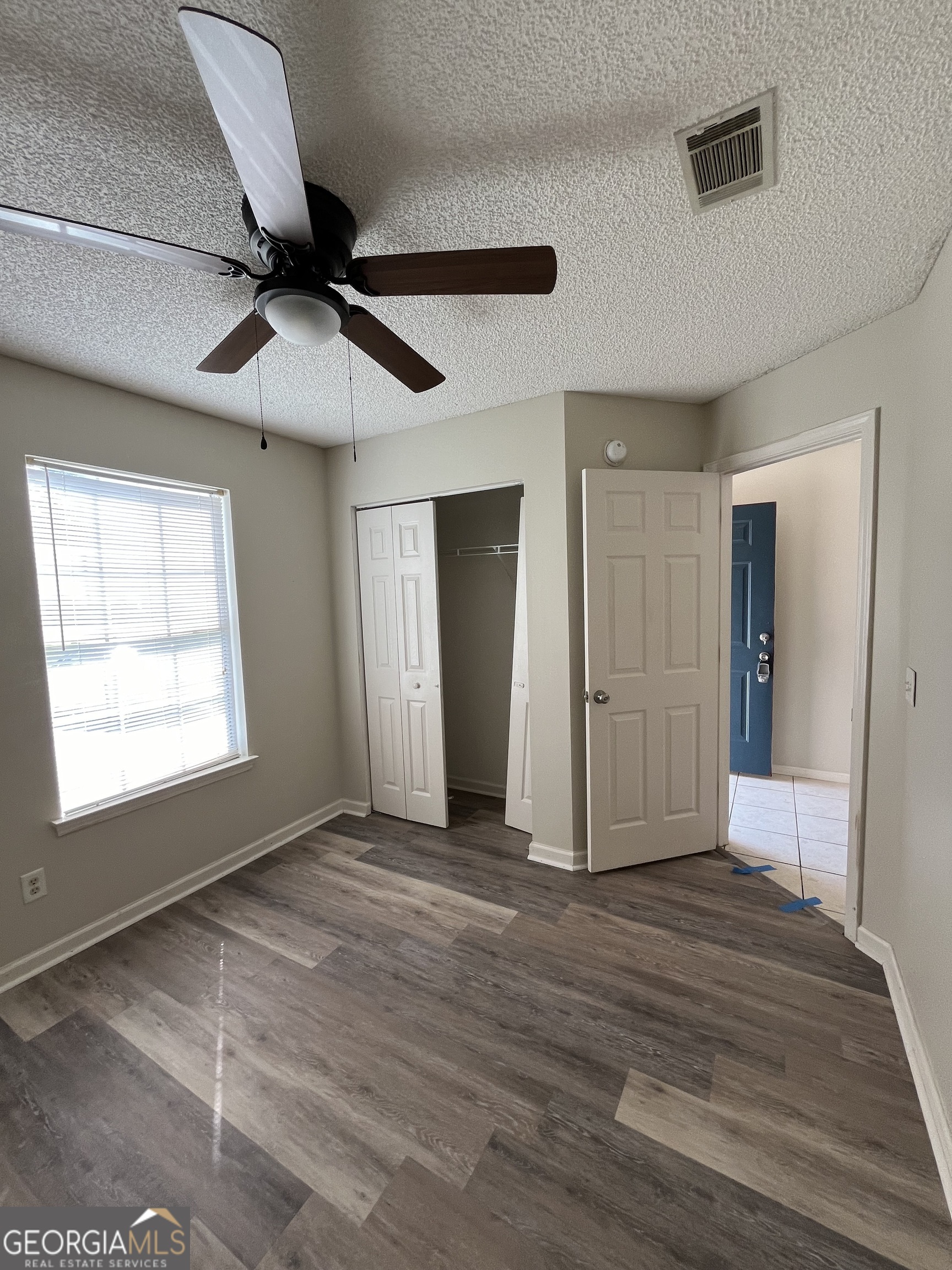 120 Sapelo Drive St. Marys, GA 31558 - Photo 4 of 24 a view of empty room with wooden floor and fan
