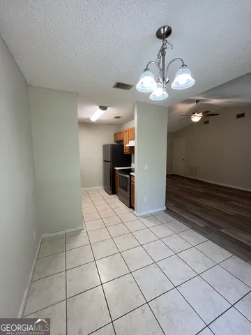 a view of a livingroom with a chandelier fan and furniture