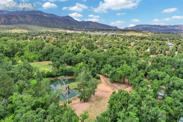 a view of a lush green outdoor space with a lake view