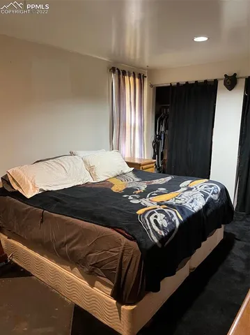 a bed sitting in a bedroom next to a window