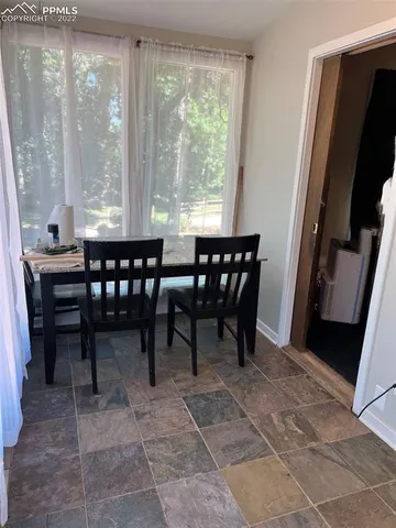 a view of a dining room with furniture and a table