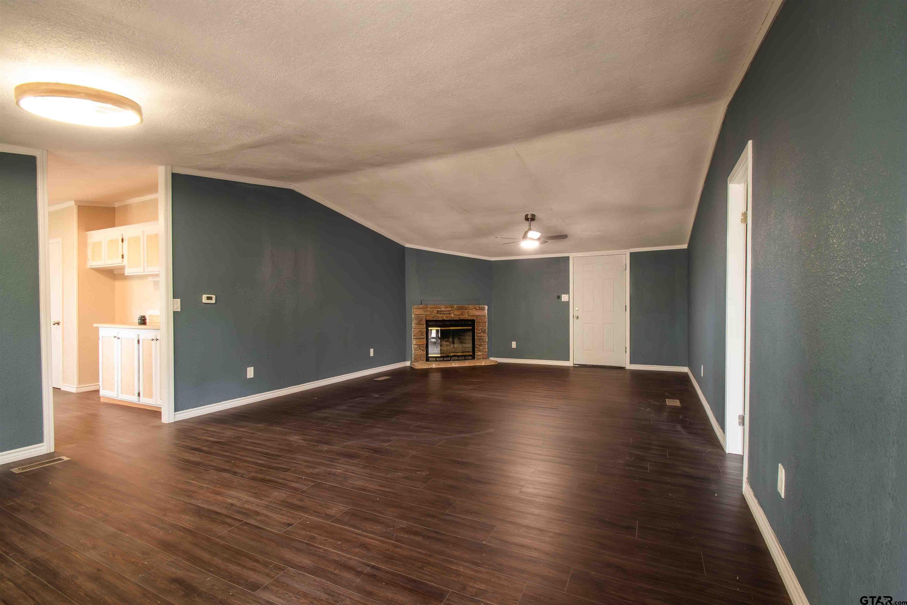 161 Clearview Circle Murchison, TX 75778 - Photo 17 of 47 a view of an empty room with wooden floor and a window