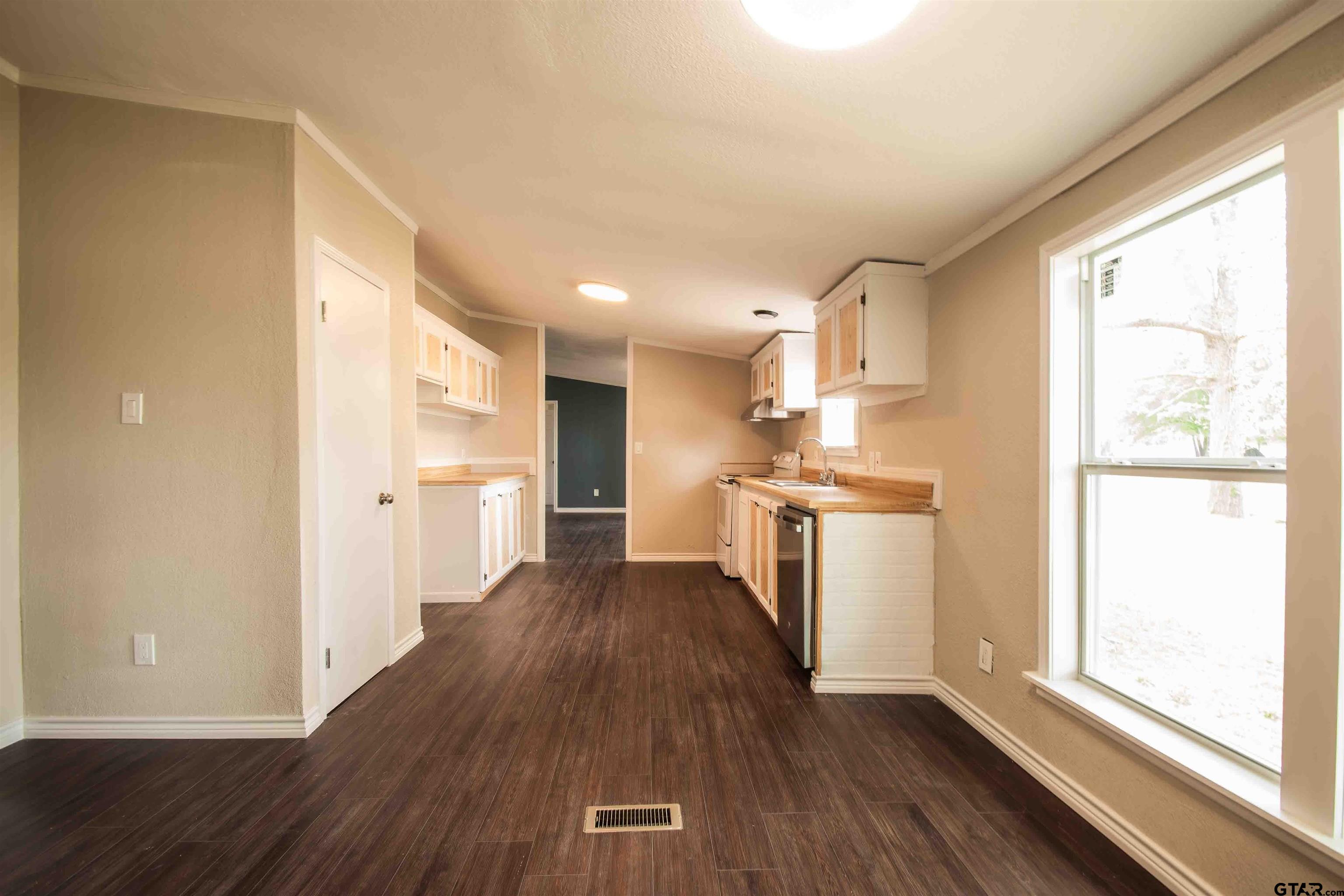 161 Clearview Circle Murchison, TX 75778 - Photo 21 of 47 a kitchen with wooden floors and white appliances