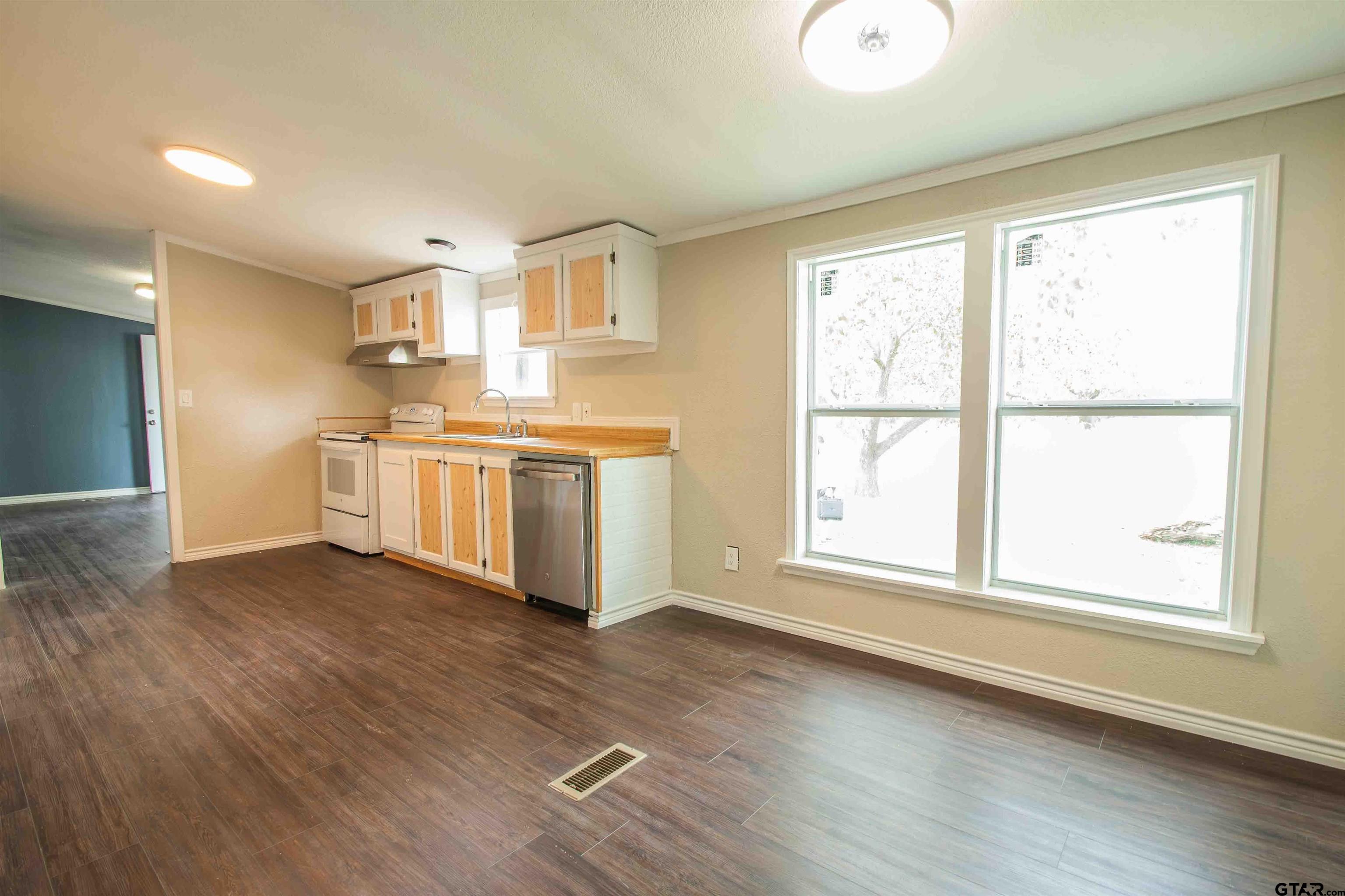 161 Clearview Circle Murchison, TX 75778 - Photo 23 of 47 a view of kitchen with wooden floor electronic appliances and windows