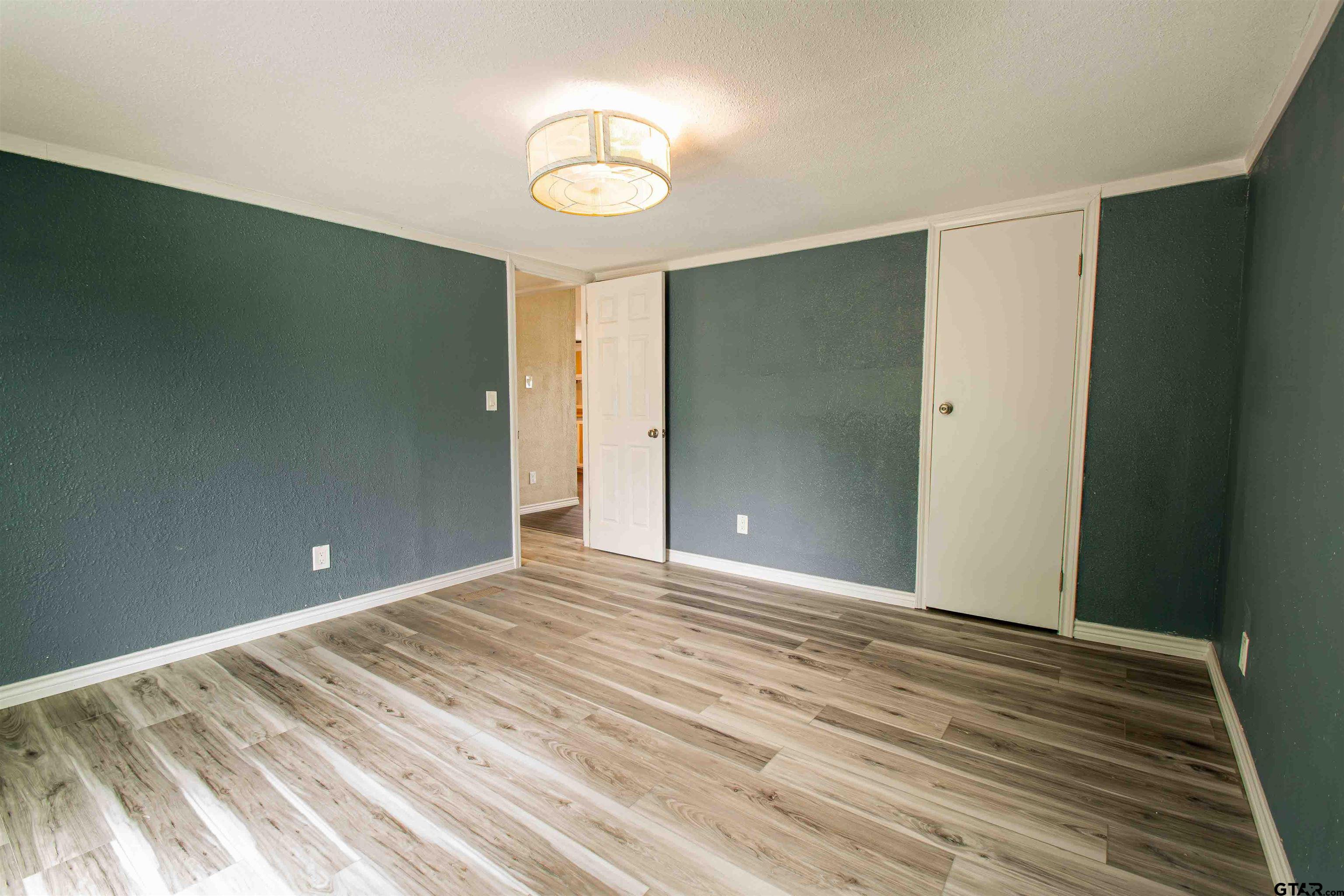 161 Clearview Circle Murchison, TX 75778 - Photo 26 of 47 a view of room with wooden floor and fan