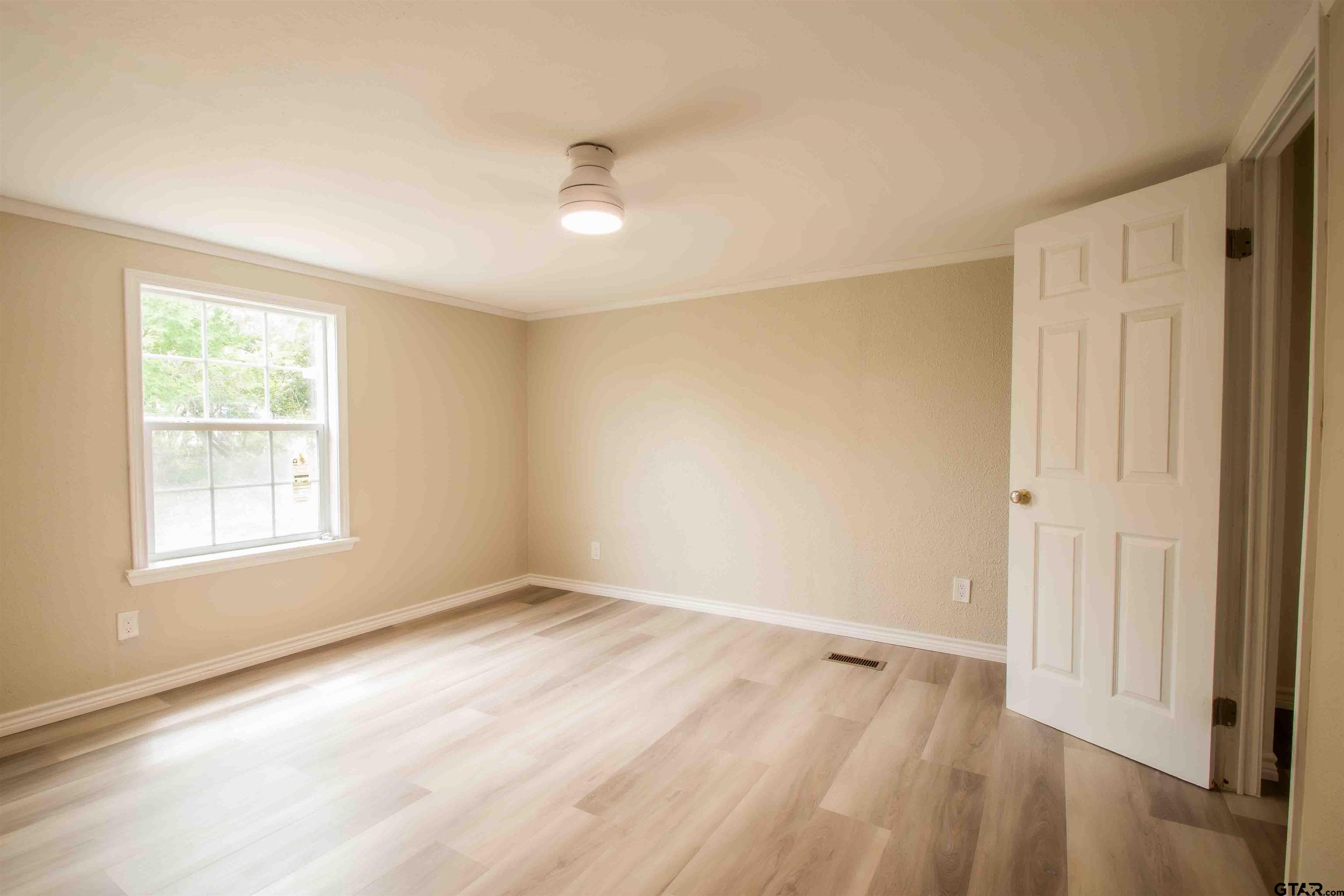 161 Clearview Circle Murchison, TX 75778 - Photo 31 of 47 an empty room with wooden floor and windows
