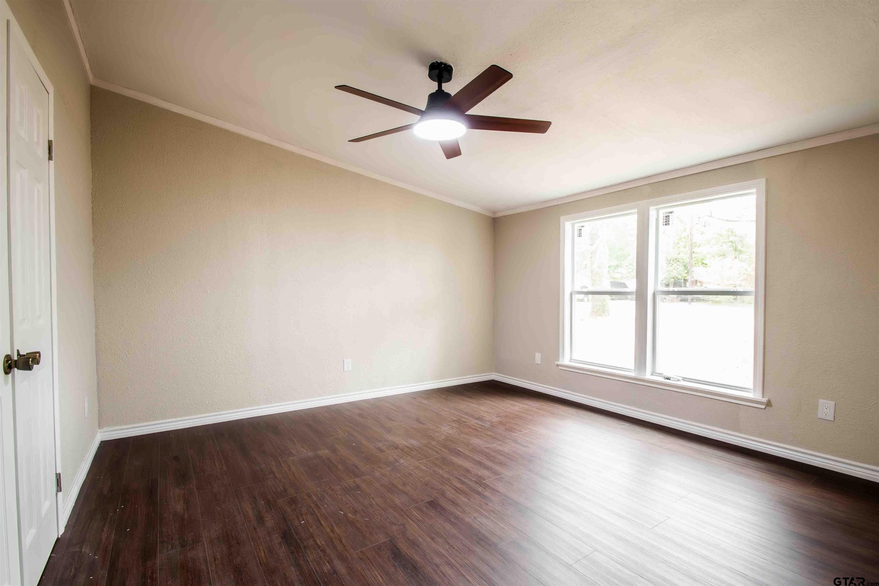 161 Clearview Circle Murchison, TX 75778 - Photo 34 of 47 an empty room with wooden floor and windows