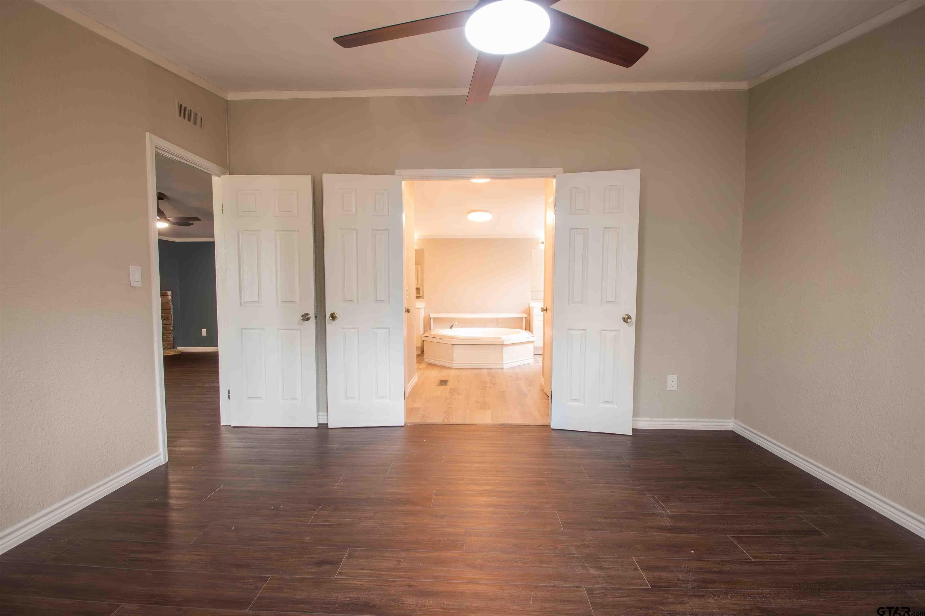 161 Clearview Circle Murchison, TX 75778 - Photo 36 of 47 an empty room with wooden floor and windows