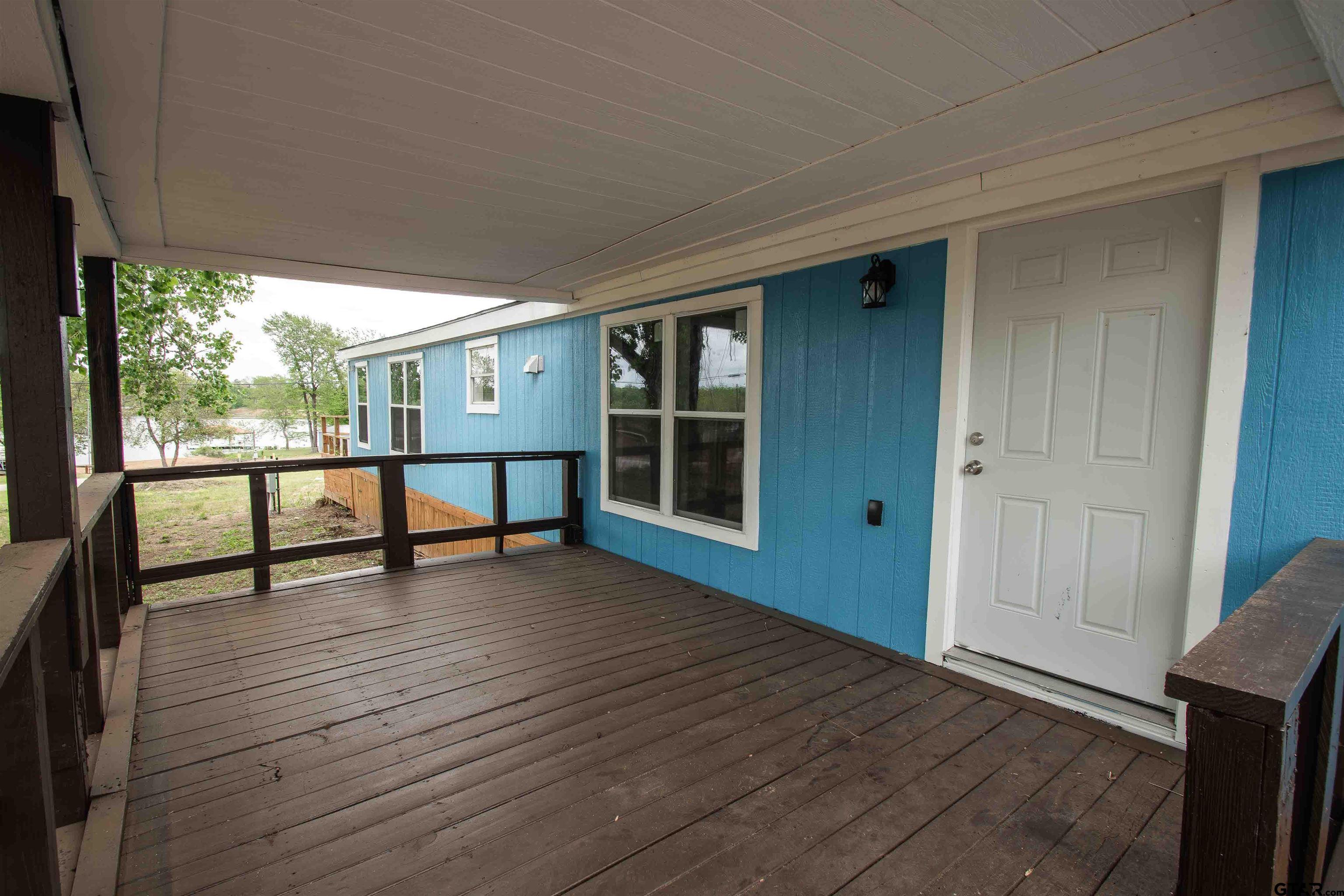 161 Clearview Circle Murchison, TX 75778 - Photo 4 of 47 a view of a porch with wooden floor and fence