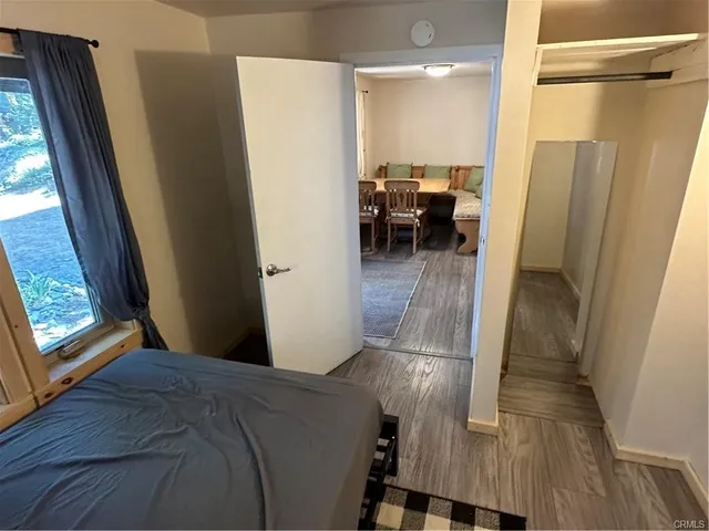 a view of a hallway and a livingroom with furniture