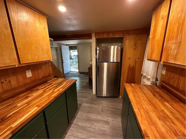 a view of a balcony with wooden floor and iron stairs
