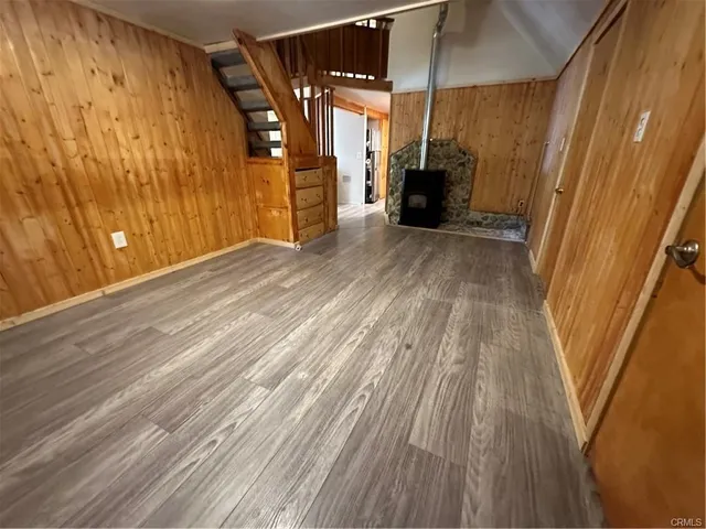 a view of a room with wooden floor