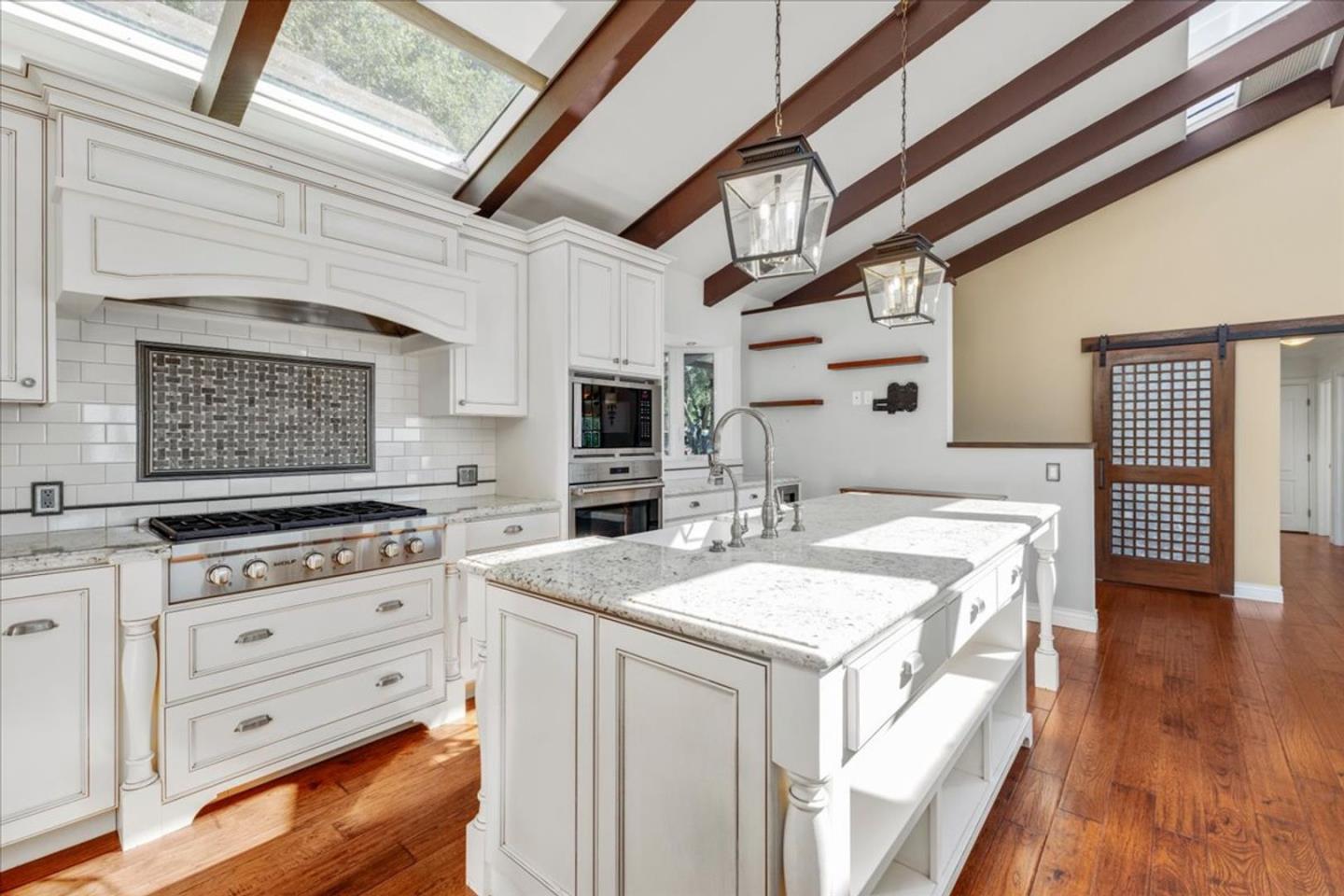 15 Mentone Road Carmel, CA 93923 - Photo 9 of 47 a kitchen with a stove a sink and a refrigerator