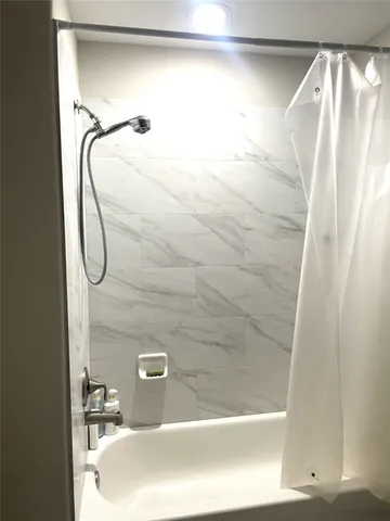 a bathroom with a glass shower door
